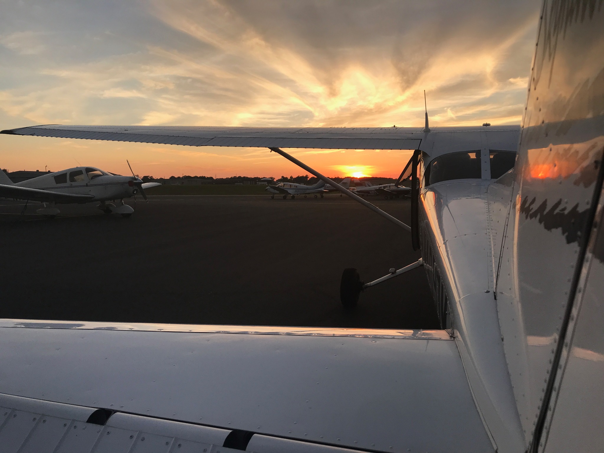 General aviation aircraft on the ramp at sunset