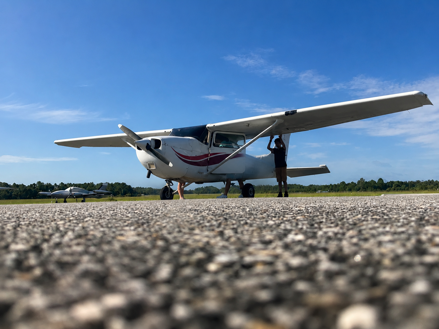 Aircraft ferry services visual showing a single-engine aircraft on a runway at sunrise
